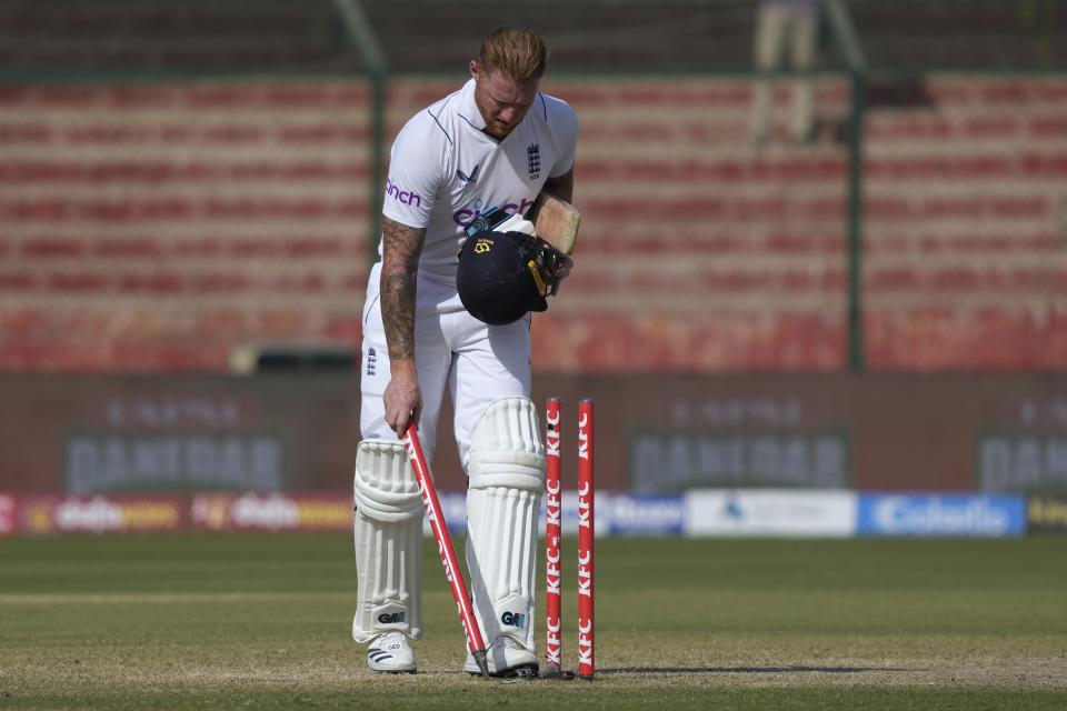 England's skipper Ben Stokes removes wicket after winning the third test cricket match against Pakistan, in Karachi, Pakistan, Tuesday, Dec. 20, 2022. (AP Photo/Fareed Khan)