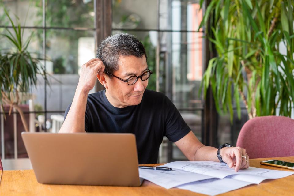 Person sitting at desk looking at documents.