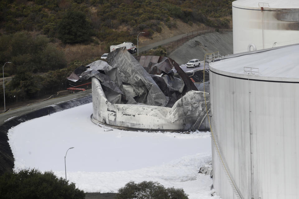 Damage from a Tuesday, Oct. 15, 2019, fire is shown at NuStar Energy fuel storage facility in Crockett, Calif., Wednesday, Oct. 16, 2019. Officials were trying to determine Wednesday if a 4.5 magnitude earthquake triggered an explosion at the fuel storage facility in the San Francisco Bay Area that started a fire and trapped thousands in their homes for hours because of potentially unhealthy air. (AP Photo/Jeff Chiu)