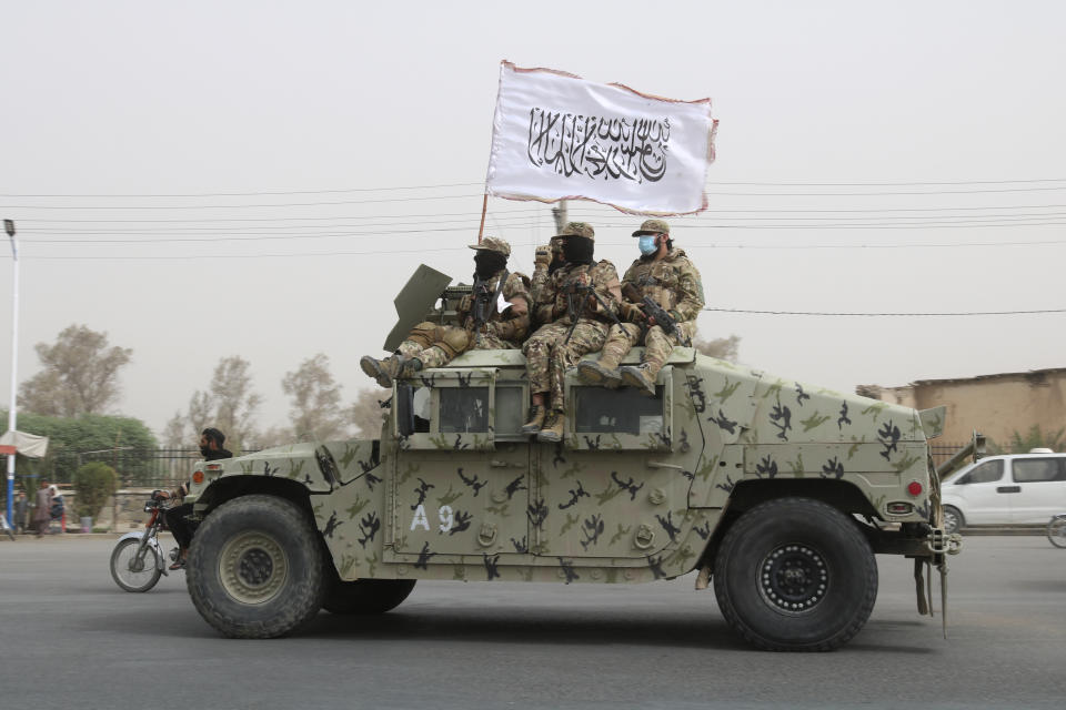 Taliban fighters patrol on the road during a celebration marking the second anniversary of the withdrawal of U.S.-led troops from Afghanistan, in Kandahar, south of Kabul, Afghanistan, Tuesday, Aug. 15, 2023. (AP Photo/Abdul Khaliq)