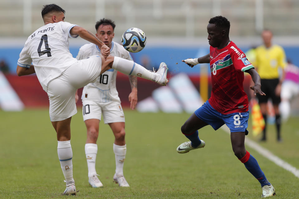 Uruguay's Mateo Ponte, left, and Gambia's Salifu Colley fight for the ball during a FIFA U-20 World Cup round of 16 soccer match at the Madre de Ciudades stadium in Santiago del Estero, Argentina, Thursday, June 1, 2023. (AP Photo/Nicolas Aguilera)