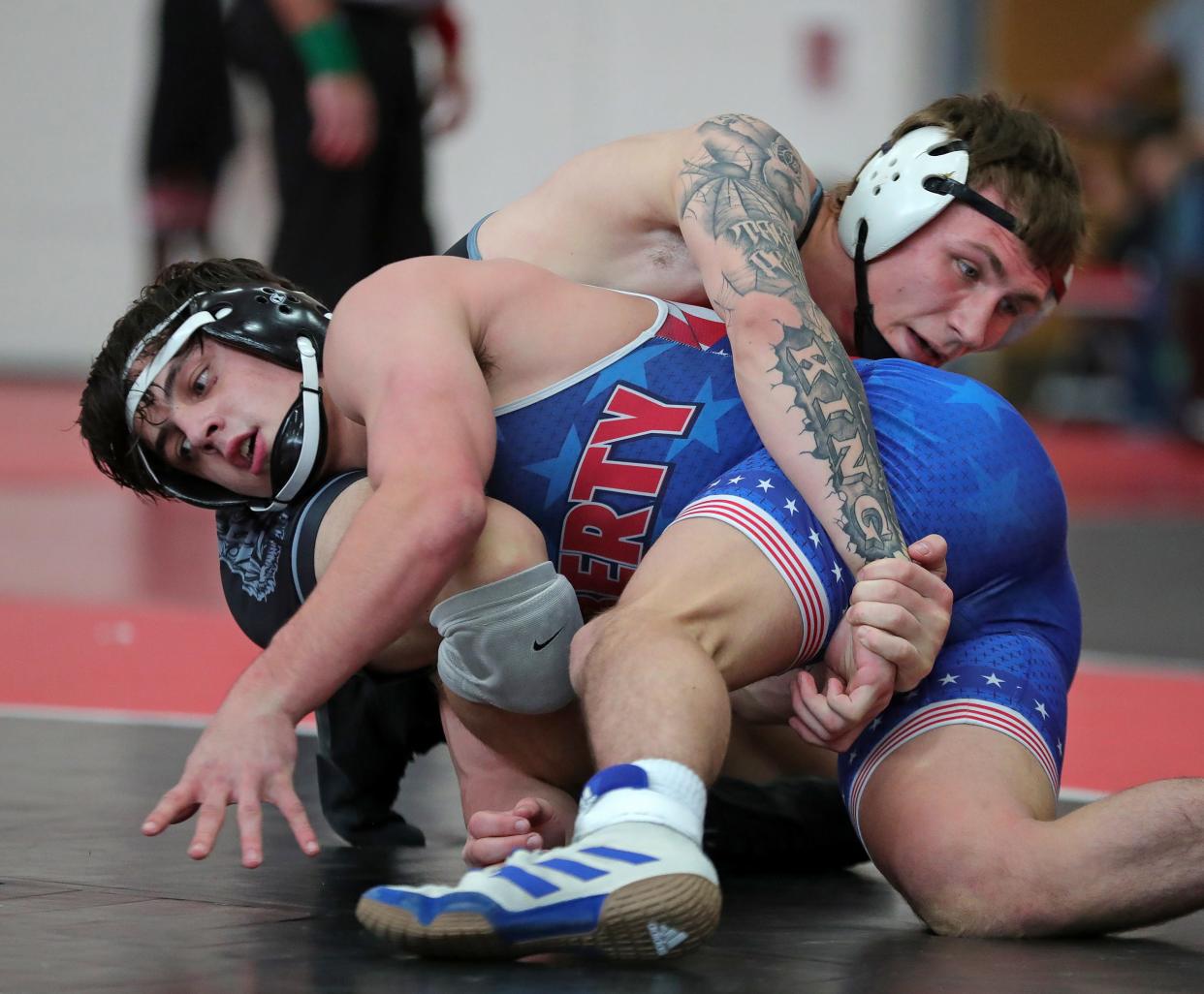 Kaden King of Buckeye, top, wrestles Tyler Deericks of Olentangy Liberty during their 157 pound match in the semifinals of the Wadsworth Grizzly Invitational Tournament, Saturday, Jan. 20, 2024, in Wadsworth, Ohio.