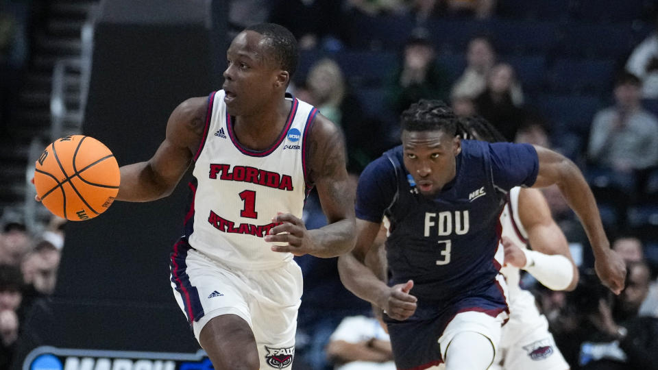 Florida Atlantic guard Johnell Davis (1) heads up court after a steal in front of Fairleigh Dickinson guard Heru Bligen (3) in the second half of a second-round college basketball game in the men's NCAA Tournament in Columbus, Ohio, Sunday, March 19, 2023. (AP Photo/Michael Conroy)