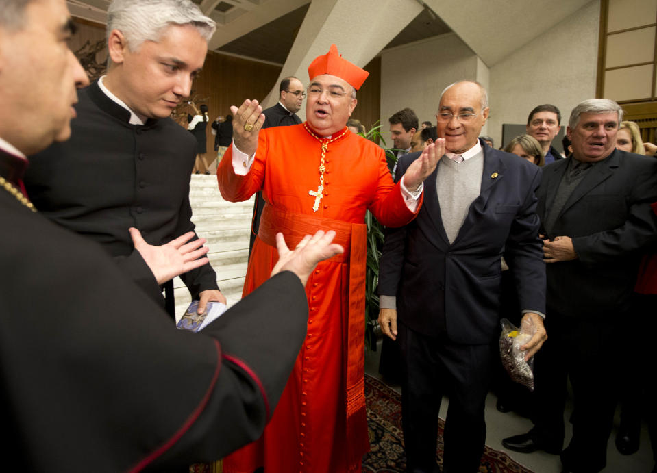 Newly-elected Cardinal Orani Joao Tempesta, archbishop of Sao Sebastiao do Rio de Janeiro, receives relatives and friends after a consistory inside the St. Peter's Basilica at the Vatican, Saturday, Feb.22, 2014. Pope Francis is putting a personal imprint on the group of men who will choose his successor, tapping like-minded cardinals from some of the world's smallest, most remote and poverty-wracked nations to help him run the Catholic Church. (AP Photo/Alessandra Tarantino)