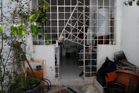 A damaged gate is seen at the residence of opposition leader Leopoldo Lopez and his family, after unidentified government officials illegally entered the house, according to the family's lawyer Omar Mora Tosta, in Caracas, Venezuela May 2, 2019. REUTERS/Carlos Garcia Rawlins