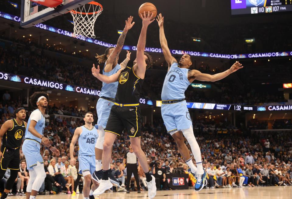 May 11, 2022; Memphis, Tennessee, USA; Memphis Grizzlies forward Brandon Clarke (15) and guard De'Anthony Melton (0) defend a shot by Golden State Warriors forward Nemanja Bjelica during game five of the second round for the 2022 NBA playoffs at FedExForum. Mandatory Credit: Joe Rondone-USA TODAY Sports