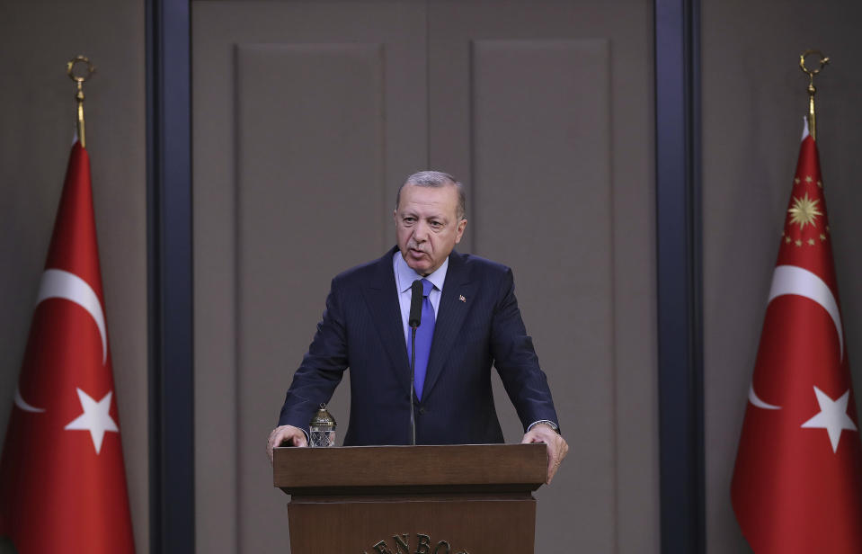 Turkish President Recep Tayyip Erdogan speaks to reporters before a visit to the United States, in Ankara, Turkey, Tuesday, Nov. 12, 2019. Erdogan warned European nations Tuesday that his country could release all the Islamic State group prisoners it holds and send them to Europe, in response to EU sanctions over Cyprus.(Presidential Press Service via AP, Pool)