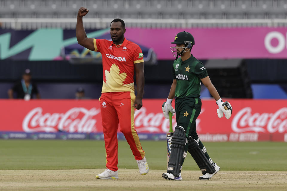 Canada's Dilon Heyliger, left, celebrates the dismissal of Pakistan's Saim Ayub, right, during the ICC Men's T20 World Cup cricket match between Pakistan and Canada at the Nassau County International Cricket Stadium in Westbury, New York, Tuesday, June 11, 2024. (AP Photo/Adam Hunger)