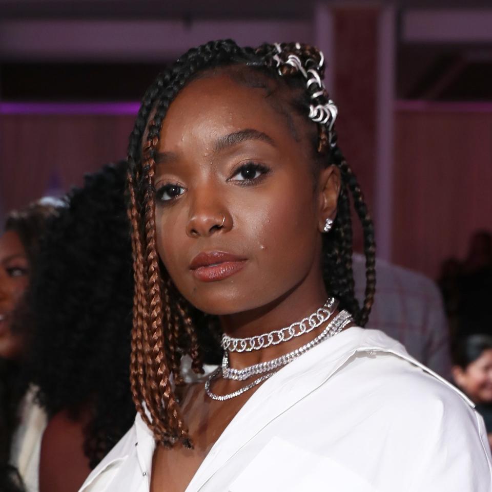 Kiki Layne demonstrates a super-cute way to style lob-length box braids. Her stylist pulled one side of her hair back behind her ears, wrapping the braids in what appears to be silver elastic.