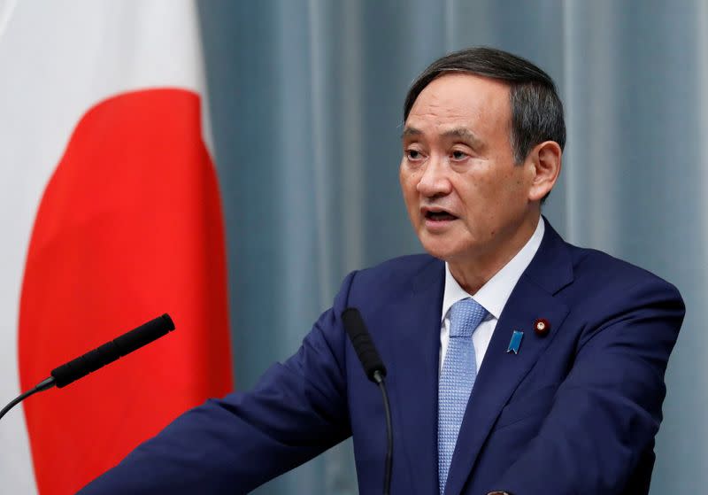 Japan's Chief Cabinet Secretary Suga speaks at a news conference after the reshuffling of the Japanese cabinet at PM Abe's official residence in Tokyo