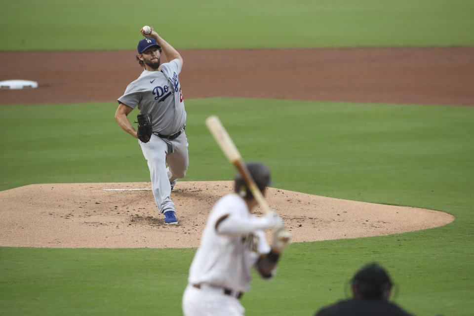 Los Angeles Dodgers starting pitcher Clayton Kershaw, top, delivers to San Diego Padres' Manny Machado in first inning of a baseball game Monday, Sept. 14, 2020, in San Diego. (AP Photo/Derrick Tuskan)