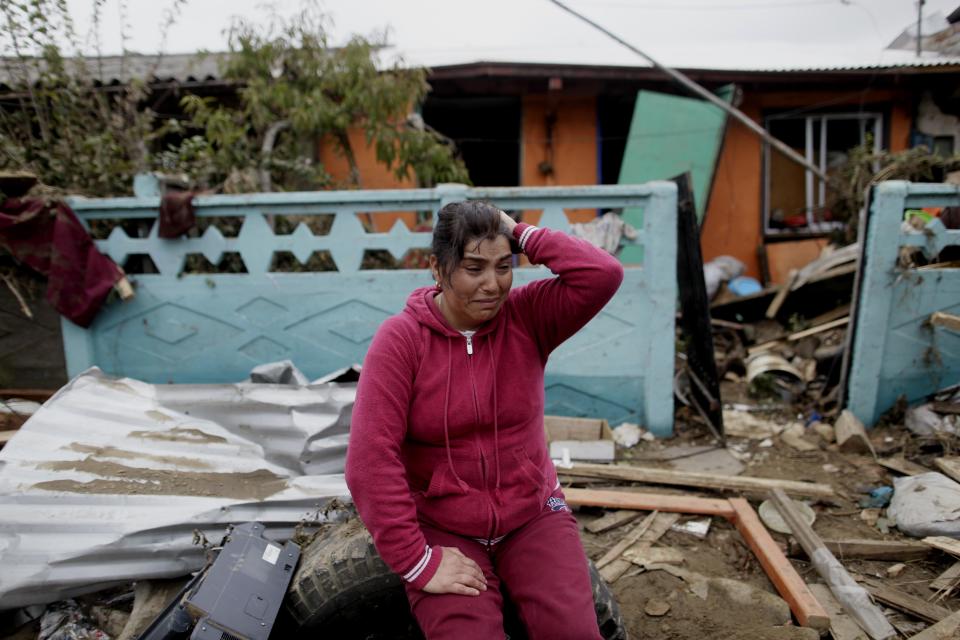 FILE - In this Monday March 1, 2010 file photo, Victoria Hernandez cries outside her parents' damaged home in Dichato, Chile. Chile marks the two-year anniversary on Monday Feb. 27, 2012 of the tsunami triggered by a magnitude-8.8 earthquake. (AP Photo/Natacha Pisarenko, File)