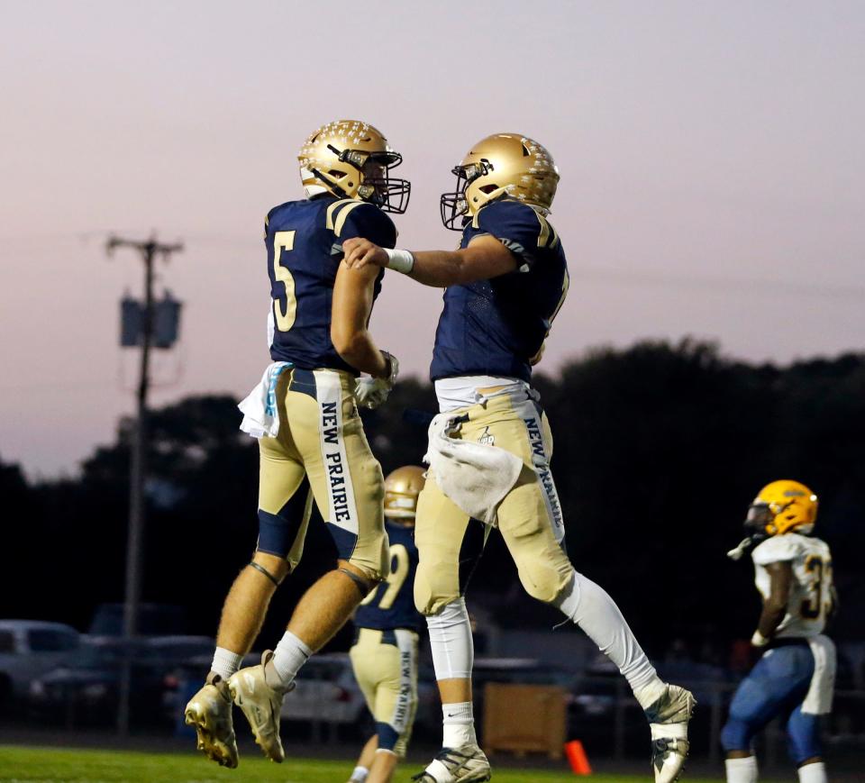 New Prairie senior Reece Lapczynski (5) and senior Marshall Kmiecik celebrate after Kmiecik threw a touchdown pass to Lapczynski in the first quarter of a football game against South Bend Riley Friday, Sept. 29, 2023, at New Prairie High School in New Carlisle.