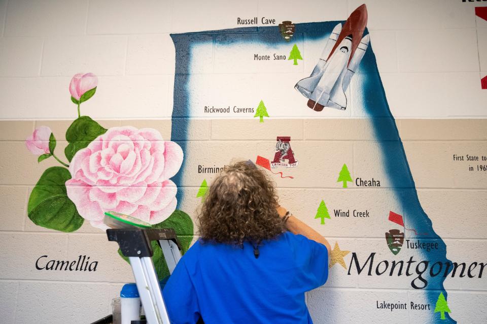 Artist Deb Mosley works on an Alabama-themed mural within Bill’s Place at Youth Villages in Memphis, Tenn., on Friday, April 19, 2024. Murals throughout the facility are based on a road trip around the country and give information about each of the states.