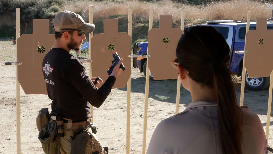 A firearms instructor with nonprofit Jewish organization Magen Am demonstrates how to unload a gun safely. - CNN