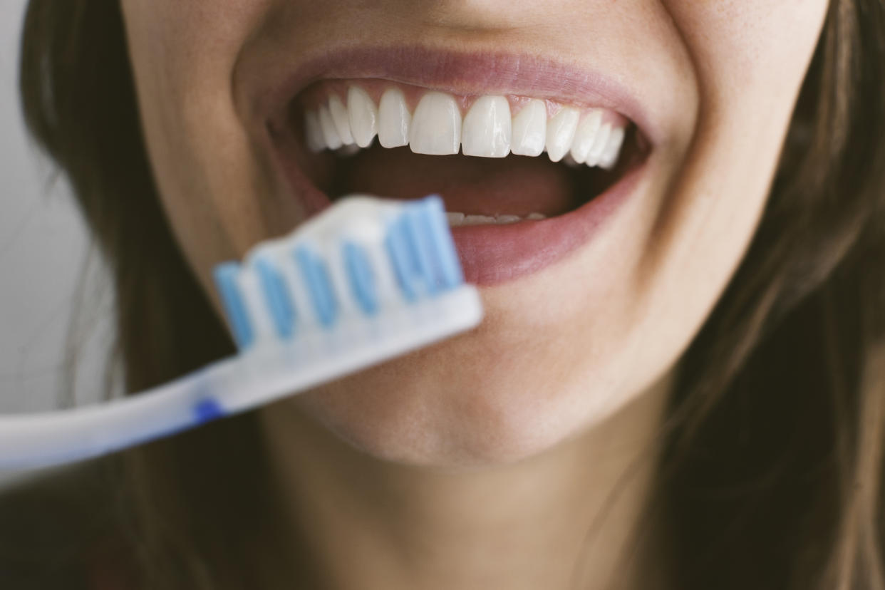 Young woman brushing teeth