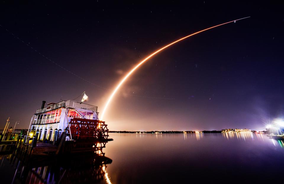 Launch of a SpaceX Falcon 9 rocket Saturday night from Cape Canaveral Space Force Station, viewed from the Cocoa Village Marina with the Indian River Queen in the foreground. The rocket appears to be soar above Jupiter in the sky.