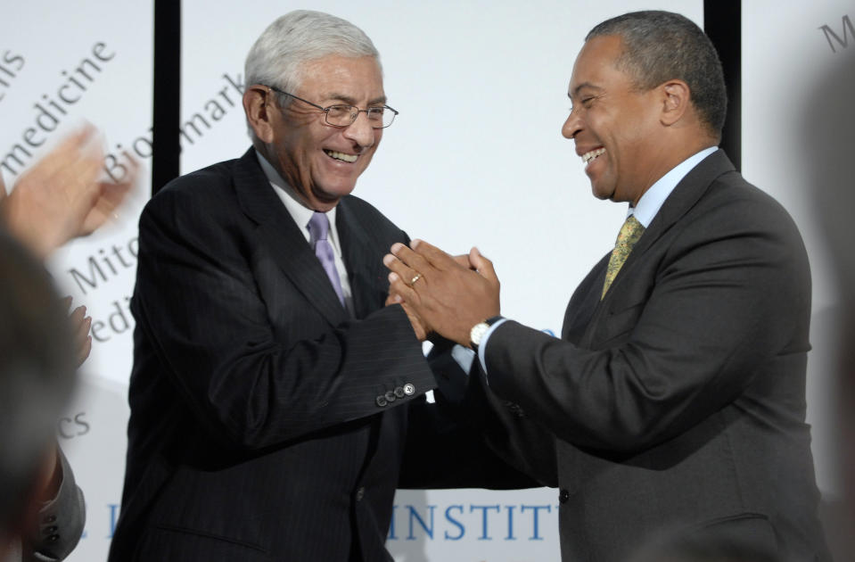 FILE - In this Sept. 4, 2008, file photo, Los Angeles Philanthropist Eli Broad, left, shakes hands with Massachusetts Gov. Deval Patrick, right, at the Broad Institute in Cambridge, Mass., after Broad announced that he and his wife Edythe Broad were donating an additional $400 million to the biomedical institute. Eli Broad, the billionaire philanthropist, contemporary art collector and entrepreneur who co-founded homebuilding pioneer Kaufman and Broad Inc. and launched financial services giant SunAmerica Inc., died Friday, April 30, 2021 in Los Angeles. He was 87. (AP Photo/Josh Reynolds, File)