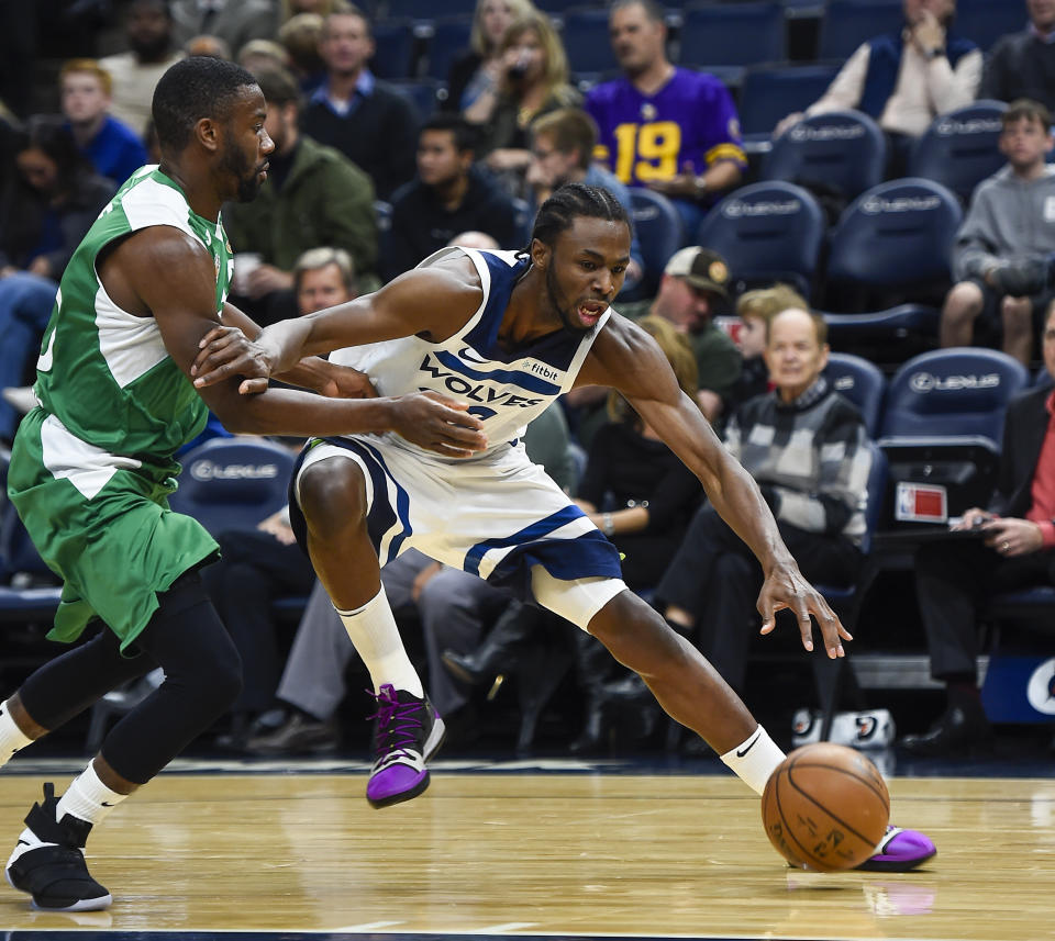 Minnesota Timberwolves forward Andrew Wiggins, right, drives past Maccabi Haifa guard Noris Cole during the first quarter of a preseason NBA basketball game Sunday, Oct. 13, 2019, in Minneapolis, Minn. (AP Photo/Craig Lassig)