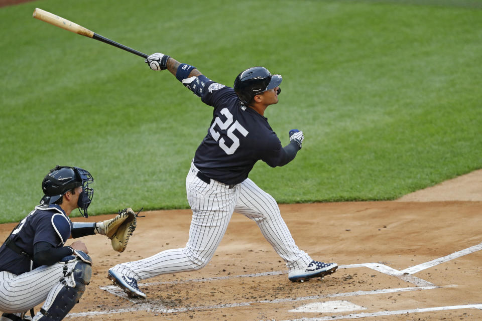 New York Yankees' Gleyber Torres follows through on his swing during an intrasquad baseball game Monday, July 6, 2020, at Yankee Stadium in New York. At left is catcher Kyle Higashioka. (AP Photo/Kathy Willens)