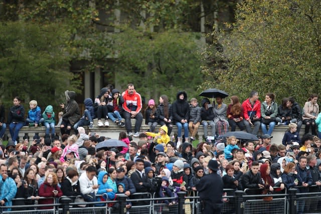 Members of the public wait to watch the Queen leave Buckingham Palace 