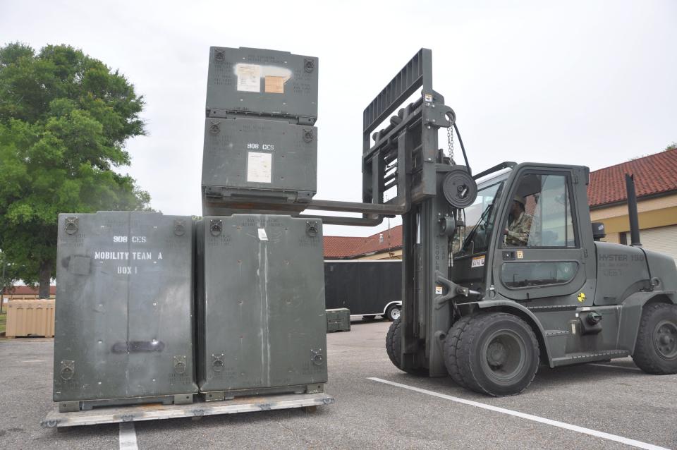 U.S. Air Force Airman 1st Class Markus Holmes, right, a heavy equipment operator in the 908th Civil Engineer Squadron, uses a forklift while another 908 CES member ground guides him during an annual training event May 5, 2023, at Maxwell Air Force Base, Alabama. U.S. Air Force Airman 1st Class Markus Holmes, right, a heavy equipment operator in the 908th Civil Engineer Squadron, uses a forklift while another 908 CES member ground guides him during an annual training event May 5, 2023, at Maxwell Air Force Base, Alabama.