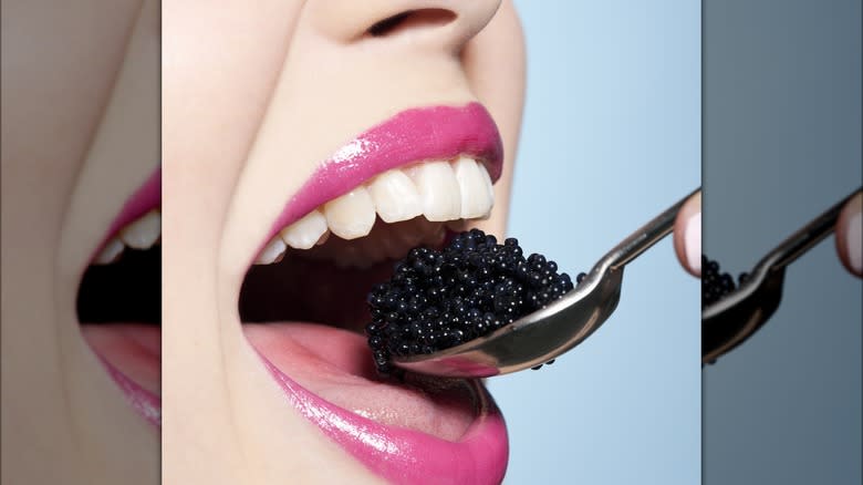 Person eating caviar 