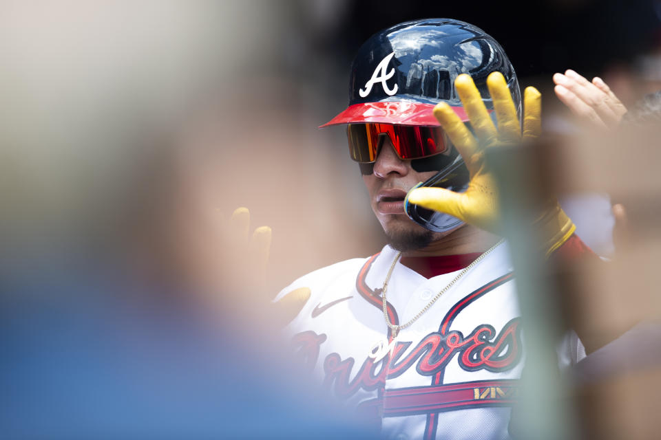 Atlanta Braves' William Contreras high-fives teammates in the dugout after a solo home run in the second inning of a baseball game against the Pittsburgh Pirates, Sunday, June 12, 2022, in Atlanta. (AP Photo/Hakim Wright Sr.)