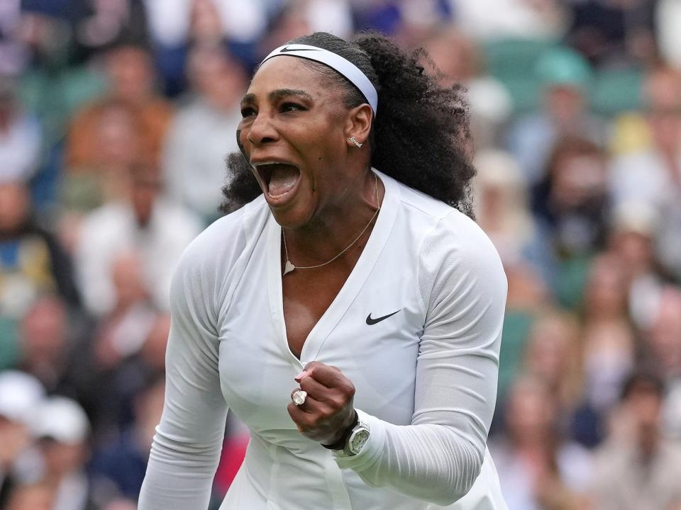 Serena Williams pumps her fist and yells during a Wimbledon match.
