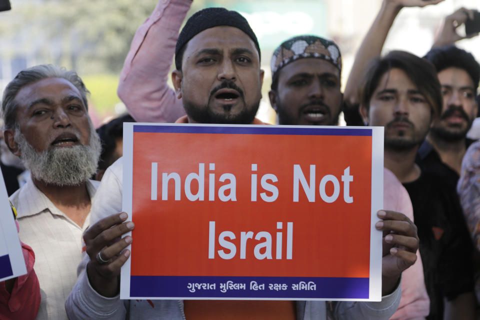 Indians holds placards and shouts slogans during a protest against Citizenship Amendment Act in Ahmadabad, India, Sunday, Dec. 15, 2019. Protests have been continuing over a new law that grants Indian citizenship based on religion and excludes Muslims. (AP Photo/Ajit Solanki)