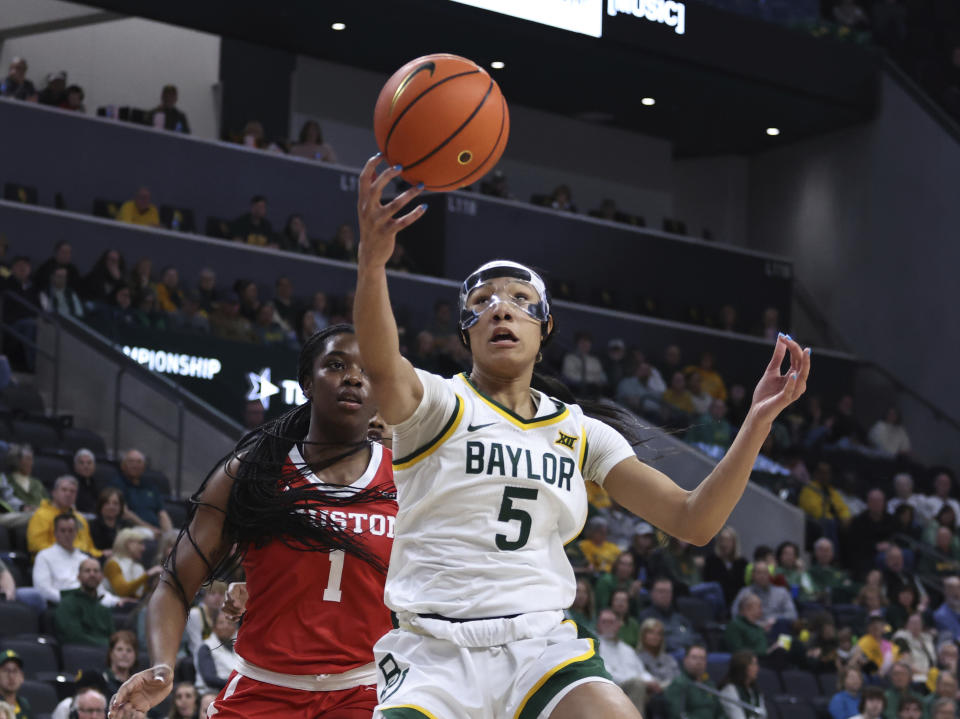 Baylor guard Darianna Littlepage-Buggs pulls down a rebound over Houston forward Bria Patterson in the first half of an NCAA college basketball game, Saturday, Jan. 6, 2024, in Waco, Texas. (Rod Aydelotte/Waco Tribune-Herald via AP)