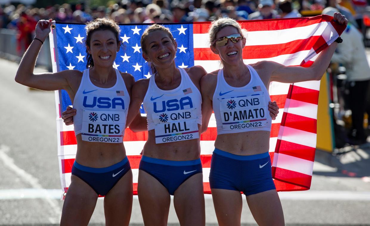 Team USA's Emma Bates, Sara Hall and Keira D'Amato pose for pictures after finishing the women's marathon at the World Athletics Championships Oregon22 Monday, July 18, 2022, in Eugene, Ore.
