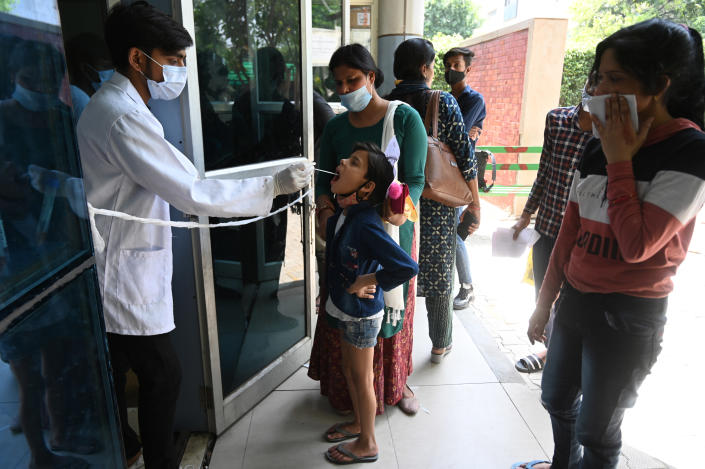 A health worker collects a swab sample for COVID-19 test on April 15, 2023, in Noida, India. (Getty Images)