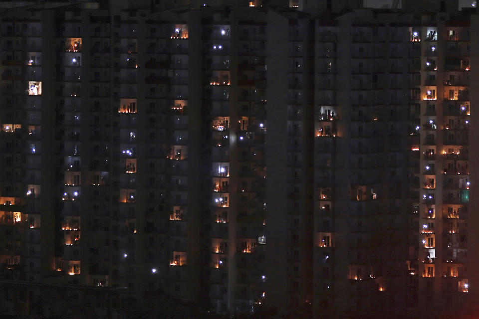 Balconies are illuminated with candles and torches to mark the country's fight against COVID-19 in Greater Noida, a suburb of New Delhi, India, April 5, 2020. Indian Prime Minister Narendra Modi had in a Friday broadcast urged the country's 1.3 billion people to switch off lights of their home at 9 pm for 9 minutes on Sunday night and light candles, lamps and even use mobile torches standing in their balconies. Modi said that such a gesture will dispel the darkness created by the coronavirus and show that people are together in their fight against the epidemic. (AP Photo/Altaf Qadri)
