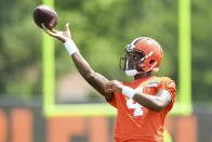 Cleveland Browns quarterback Deshaun Watson throws a pass during the NFL football team's training camp, Monday, August 1, 2022, in Berea, Ohio. Watson was suspended for six games on Monday after being accused by two dozen women in Texas of sexual misconduct during massage treatments, in what a disciplinary officer said was behavior “more egregious than any before reviewed by the NFL.” (AP Photo/Nick Cammett)