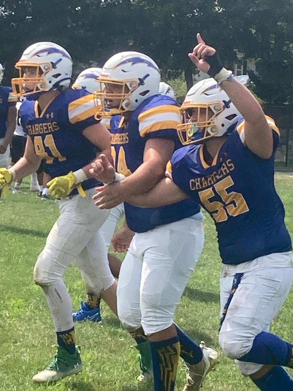 Spotswood football players Jony Lopez (41), Kyle Chigas (74) and Quin Esser (55) celebrate after Esser scored a three-yard touchdown run with seven minutes left in the second quarter to make it 21-0 against Brearley on Sept. 9, 2023