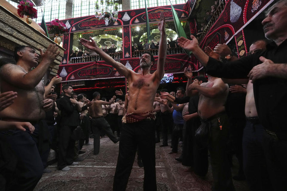 Iranian and Iraqi Shiite Muslims beat their heads and chests during the Ashoura mourning ritual in downtown Tehran, Iran, Friday, July 28, 2023. Millions of Shiite Muslims in Iran, Afghanistan, Pakistan and around the world on Friday commemorated Ashoura, a remembrance of the 7th-century martyrdom of the Prophet Muhammad's grandson, Hussein, that gave birth to their faith. (AP Photo/Vahid Salemi)