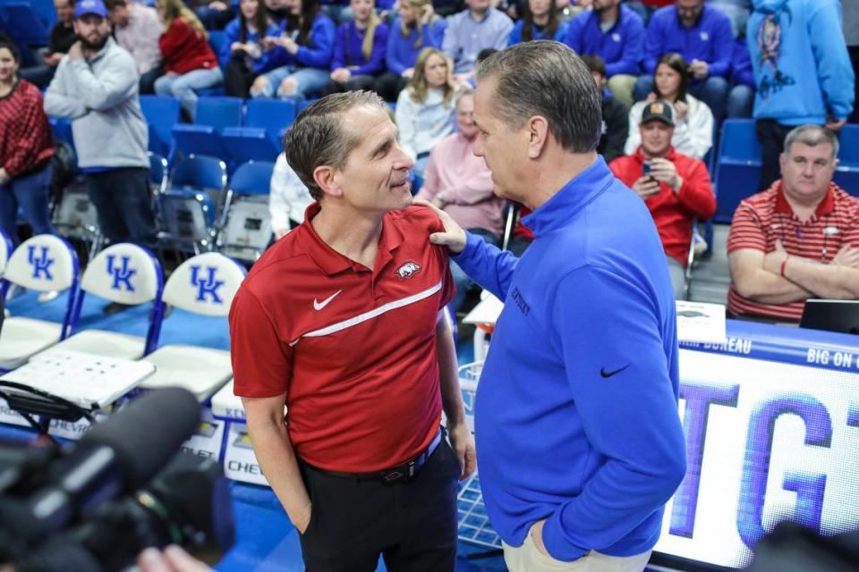 Arkansas coach Eric Musselman, left, and Kentucky coach John Calipari talk before a game in Rupp Arena last season.