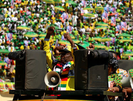Zimbabwe's President Emmerson Mnangagwa greets supporters gathered for his final campaign rally at a stadium in Harare, Zimbabwe, July 28, 2018. REUTERS/Philimon Bulawayo
