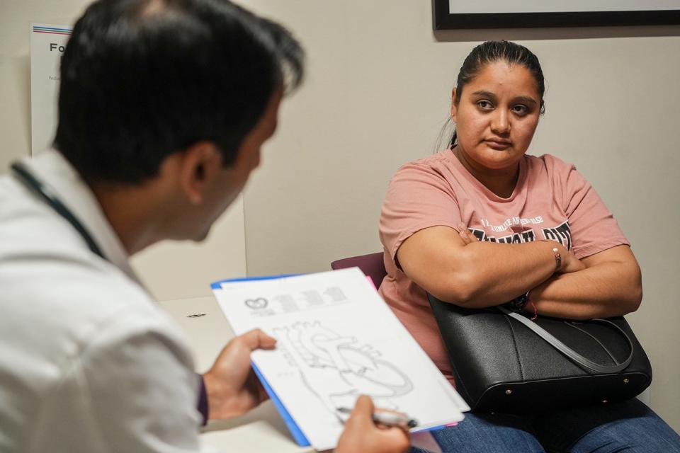Dr. Hitesh Agrawal explains to Laura Rojas the future heart surgery her son, Juan Amador, 13, will have later this summer to close a hole in his heart.
