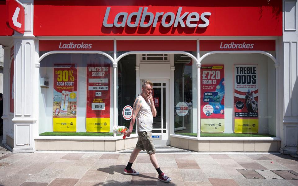 Ladbrokes owner Entain reduced its losses in the first half of the year