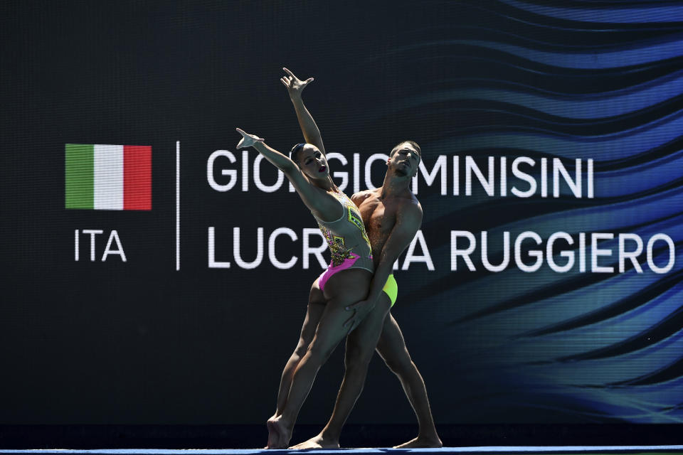 FILE - Italy's Giorgio Minisi and Lucrezia Ruggiero compete during the mixed duet technical final of the artistic swimming at the 19th FINA World Championships in Budapest, Hungary, on June 20, 2022. Men can compete in Olympic artistic swimming for the first time at the 2024 Paris Games, the World Aquatics governing body said Thursday, Dec. 22, 2022. (AP Photo/Anna Szilagyi, File)