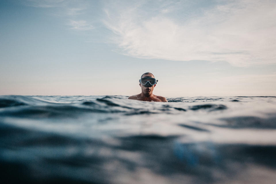 Man swimming in sea with scuba mask