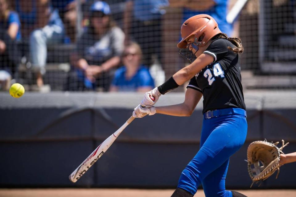 Capital Christian Cougars batter Brianna Johnson (24) hits a sacrifice fly ball during the seventh inning against the Dixon Rams at the CIF Sac-Joaquin Section Division IV high school softball championship game Saturday, May 27, 2023, at Cosumnes River College.