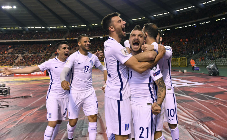 Greece's Kostas Stafylidis, center, celebrates with team mates after Greece scored a first match goal during the Euro 2018 Group H qualifying match between Belgium and Greece at the King Baudouin stadium in Brussels on Saturday, March 25, 2017. (AP Photo/Geert Vanden Wijngaert)