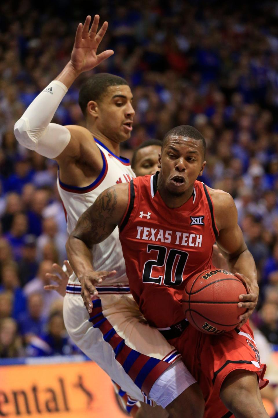 Texas Tech guard Toddrick Gotcher (20) and Kansas forward Landen Lucas, left, during the second half of an NCAA college basketball game in Lawrence, Kan., Saturday, Feb. 27, 2016. Kansas defeated Texas Tech 67-58. Kansas clinched a tie for their 12th Big 12 title. (AP Photo/Orlin Wagner)