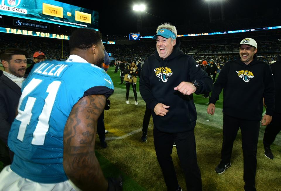 Jacksonville Jaguars head coach Doug Pederson is greeted by linebacker Josh Allen (41) as he leaves the field after Saturday night's victory over the Chargers. The Jacksonville Jaguars hosted the Los Angeles Chargers in their first round playoff game Saturday, January 14, 2023 at TIAA Bank Field in Jacksonville, Fla. The Jaguars trailed 27 to 7 at the half but came back to win the game 31 to 30. [Bob Self/Florida Times-Union]