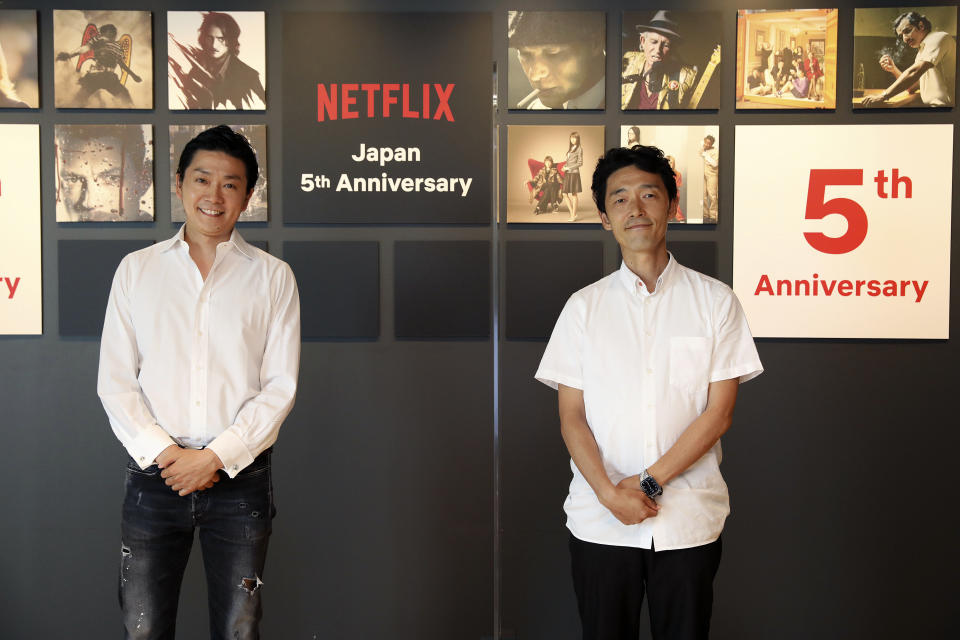 In this photo released by Netflix, Kaata Sakamoto, left, director of its content acquisition, and filmmaker Shinsuke Sato attend a livestream held from the Netflix Tokyo office on Sept. 7, 2020. After five years in Japan, Netflix now has 5 million households that have signed with the video-streaming service. The coronavirus pandemic, which has people staying home, has helped. But that number is still a fraction of Netflix's 193 million global paid members, and just 10% of Japan, where old-fashioned TV remains popular. Sato directs a live-action adaptation of cult manga, “Alice in Borderland” for Netflix. (Netflix via AP)