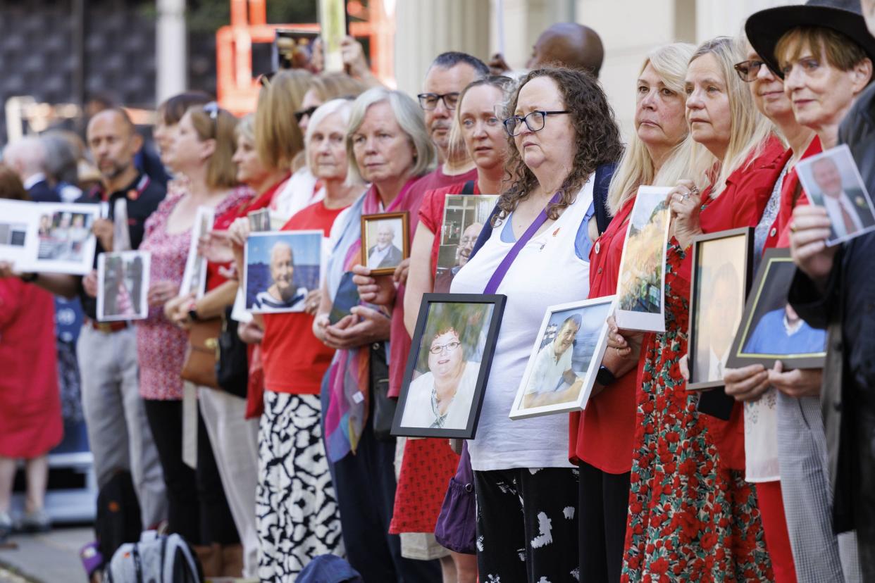 Bereaved relatives held pictures of loved ones lost during the pandemic outside the inquiry (Belinda Jiao/PA) (PA Wire)