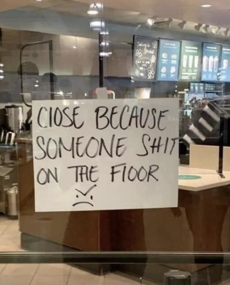 A handwritten sign on a Starbucks window reads: "Close because someone shit on the floor" with a sad face emoji drawn below the text